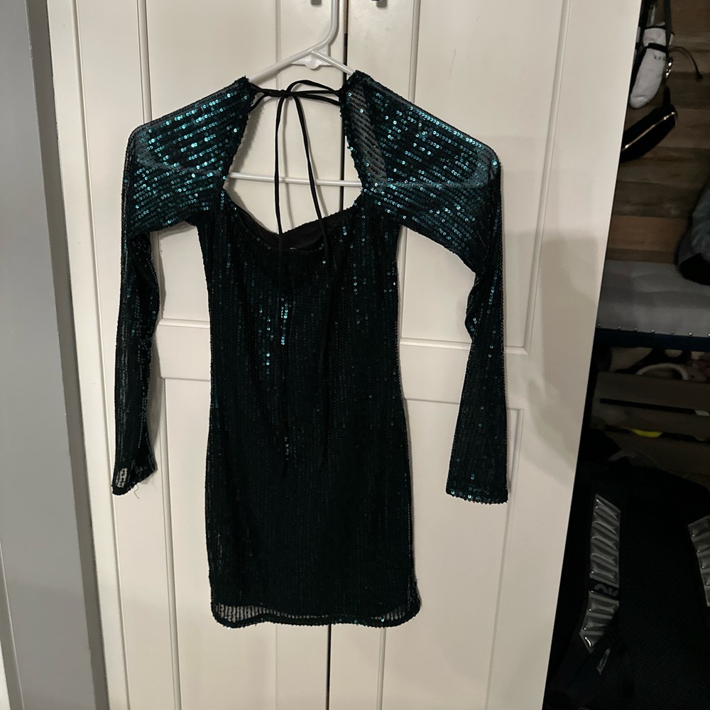 Features a trendy neckline, long sleeves and a flattering body con fit.